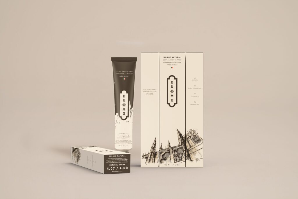 Duomo 4.07 / 4NB - Milano Natural Natural Brown hair color tube and boxes on a beige backdrop