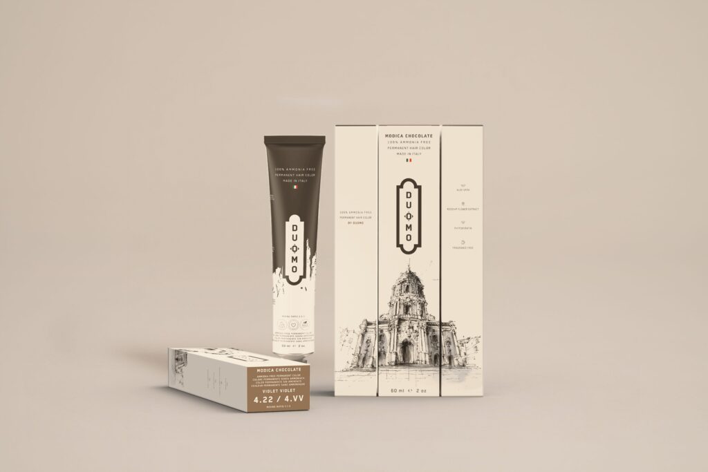 Duomo 4.22 / 4VV - Modica Chocolate Violet hair color tube and boxes on a beige backdrop