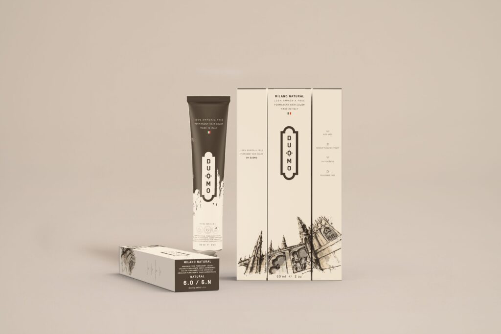 Duomo 6.0 / 6N - Milano Natural Natural hair color tube and boxes on a beige backdrop