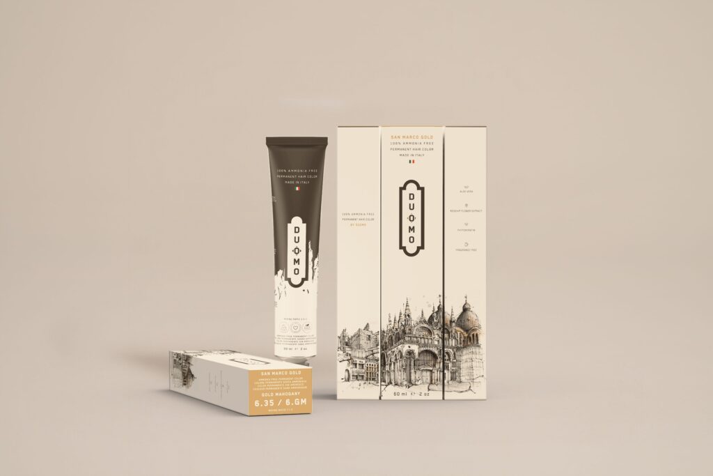 Duomo 6.35 / 6GM - San Marco Gold - Gold Mahogany hair color tube and boxes on a beige backdrop