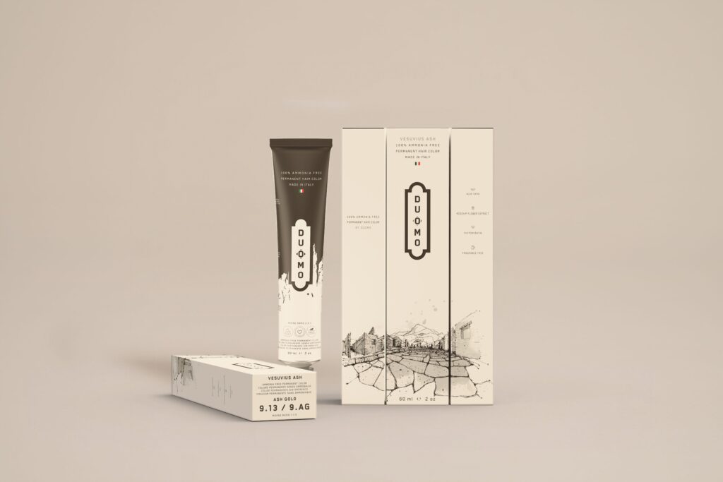Duomo 9.13 / 9AG - Vesuvius Ash - Ash Gold hair color tube and boxes on a beige backdrop