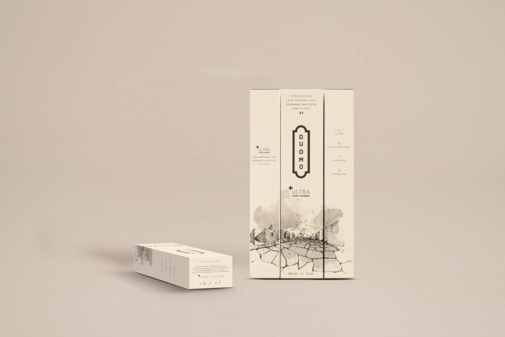 Duomo A+ Ultra Light Ash hair color tube and boxes on a beige backdrop