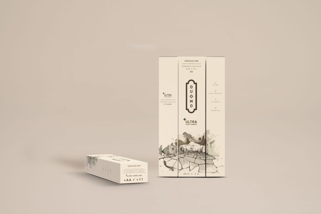 Duomo AA+ Ultra Dark Ash hair color tube and boxes on a beige backdrop