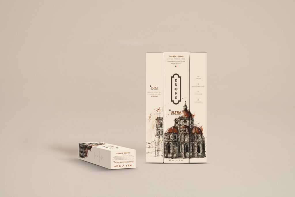 Duomo CC+ Ultra Copper Copper hair color tube and boxes on a beige backdrop