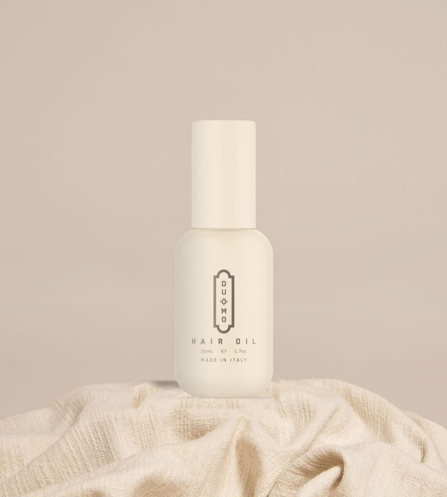 Duomo Hair Oil 50 mL bottle on natural linen cloth