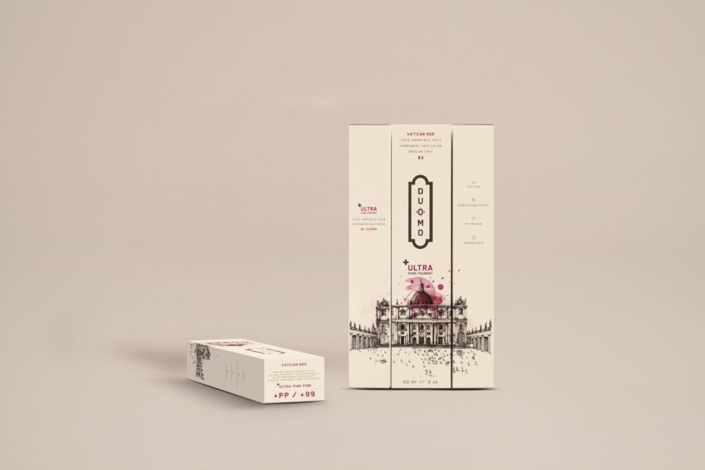 Duomo PP+ Ultra Pink Pink hair color tube and boxes on a beige backdrop