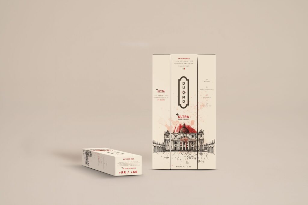 Duomo RR+ Ultra Red Red hair color tube and boxes on a beige backdrop