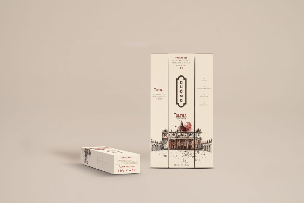 Duomo RV+ Ultra Red Violet hair color tube and boxes on a beige backdrop