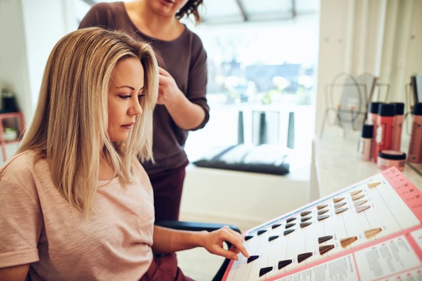 client helps evaluate a professional hair color line during a salon consultation