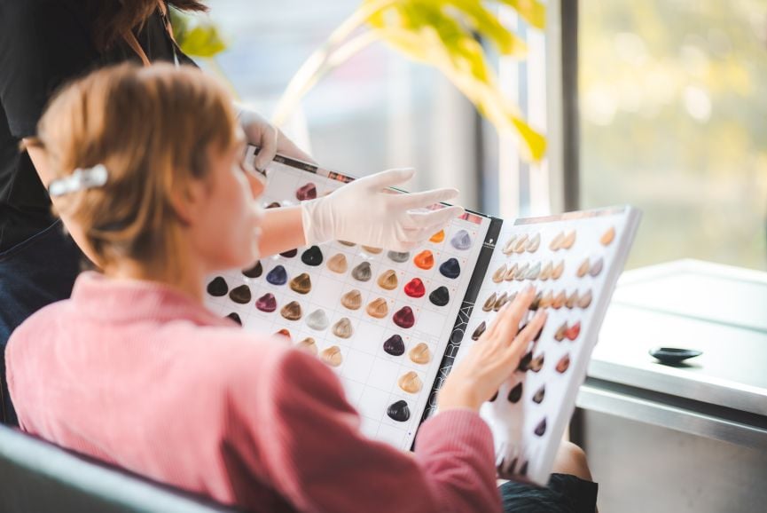 salon client discusses a new professional hair color line with her stylist