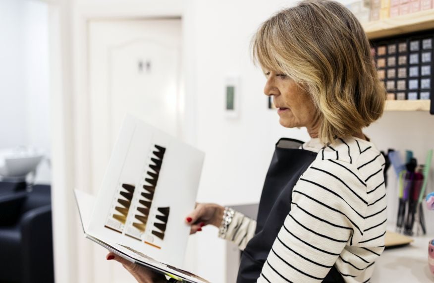 salon owner evaluates a professional hair color line using a shade chart